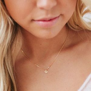 Made by Mary hand stamped “L” 1/4 inch gold filled disc